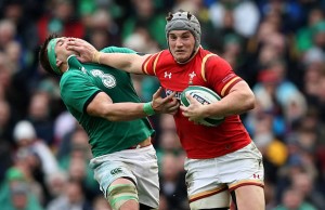 Jonathan Davies shpves off CJ Stander in the tackle