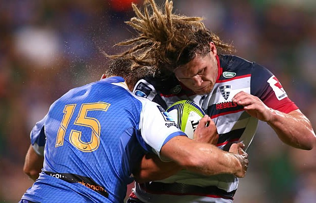 Jordy Reid of the Rebels gets tackled by Dane Haylett-Petty of the Force