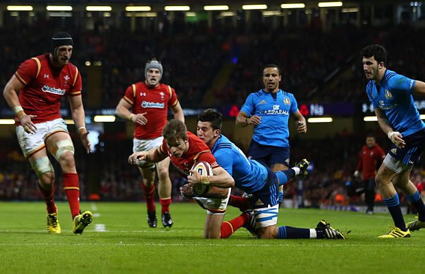 Liam Williams gets brought to ground by the Italian defence