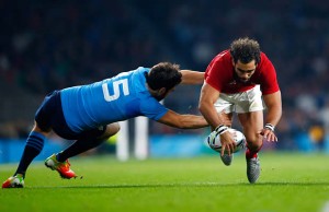Yoann Huget is tackled by Luke McLean from Italy