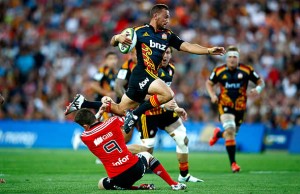 Aaron Cruden avoids a tackle while Sam Cane runs behind in support