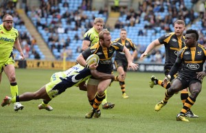 Dan Robson of Wasps is tackled by Neville Edwards of Sale Sharks