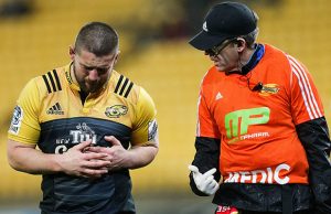 Dane Coles holds his rib cage in pain in the quarter finals