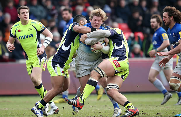 Jared Saunders of Saracens is tackled by Johnny Leota