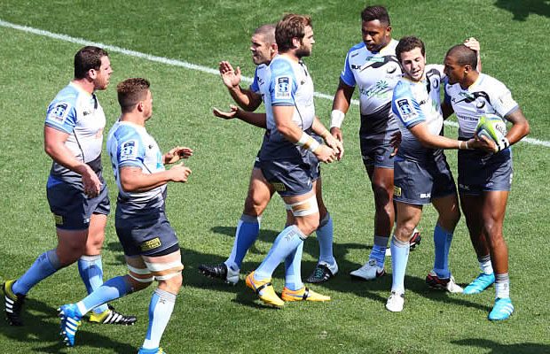 Marcel Brache celebrates a try with his team mates