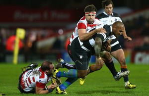 Nemani Nadolo is tackled by Gloucester's defence
